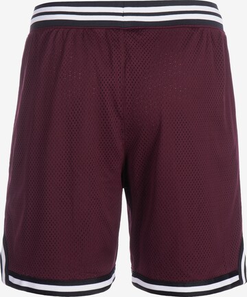 Loosefit Pantalon de sport 'Curry' UNDER ARMOUR en rouge