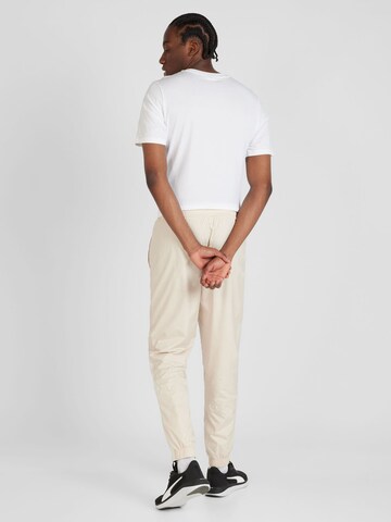 PUMA Slimfit Spodnie sportowe 'OM Prematch' w kolorze beżowy