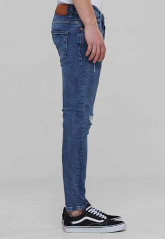 Skinny Jeans di Karl Kani in blu