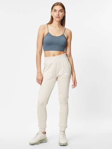 Effilé Pantalon de sport 'Legacy' Hummel en beige