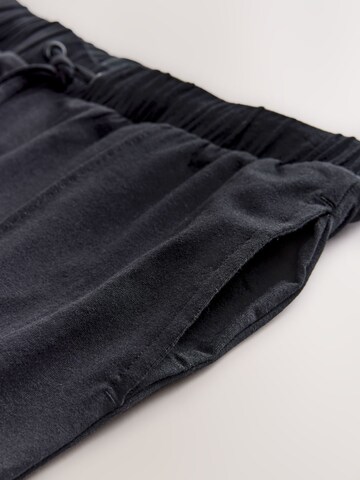 Next Tapered Housut värissä musta