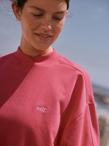 Sweat-shirt self. en rose