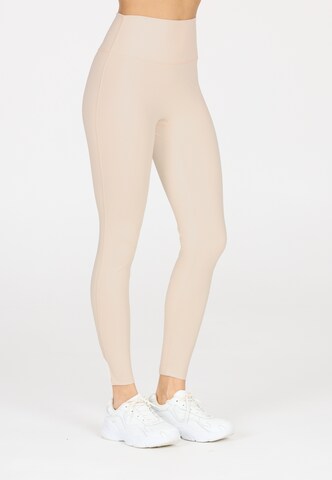 Athlecia Slim fit Leggings in Beige: front