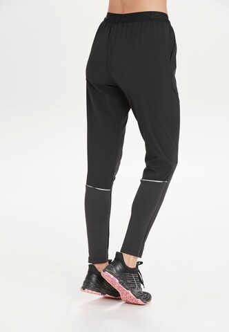 ENDURANCE Tapered Sports trousers 'Wind' in Black