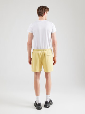 Nike Sportswear Loose fit Trousers 'CLUB' in Yellow