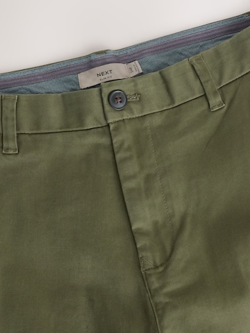Next Slimfit Chinohousut värissä vihreä