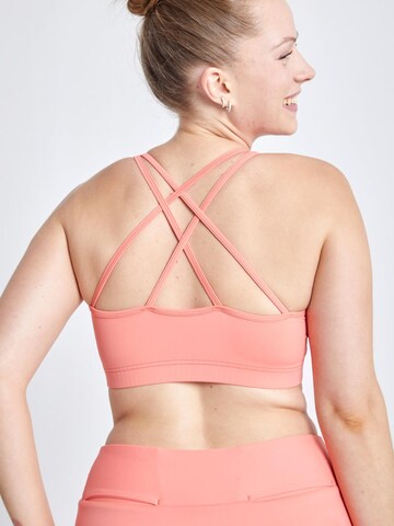 SPORTKIND Medium support Sport bh 'Crossed Straps' in Oranje