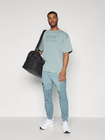 UNDER ARMOUR Λειτουργικό μπλουζάκι 'ATHLETES' σε μπλε