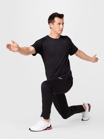 Effilé Pantalon de sport PUMA en noir