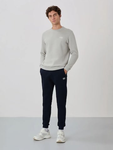 Tommy Life Trainingspak in Blauw: voorkant
