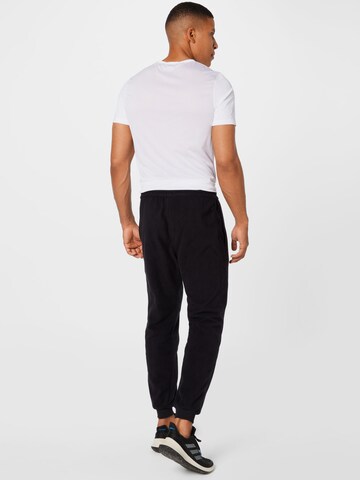 Tapered Pantaloni sportivi di Reebok in nero