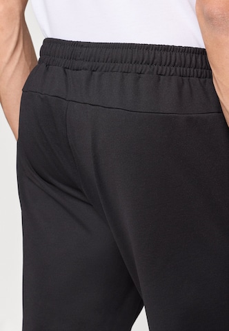 Tapered Pantaloni sportivi 'FNK' di 4F in nero