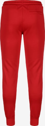 PUMA - Tapered Calças de desporto 'Iconic T7' em vermelho