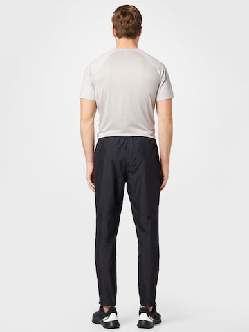 Effilé Pantalon de sport ASICS en noir