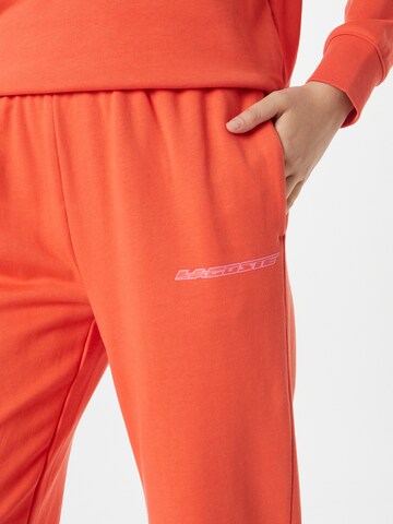 LACOSTE Tapered Broek in Oranje