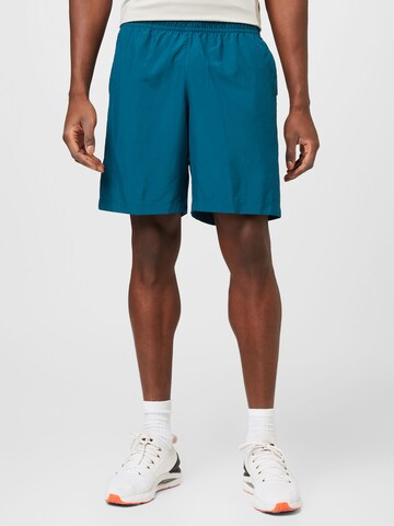 UNDER ARMOUR Regular Workout Pants in Green: front