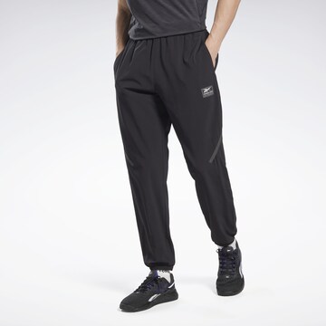 Reebok Tapered Workout Pants in Black: front