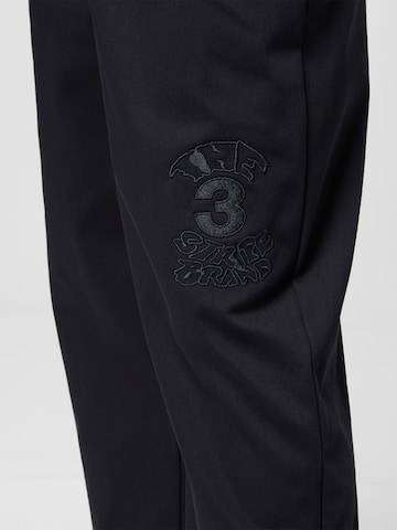 Tapered Pantaloni 'Graphics Campus Chino' di ADIDAS ORIGINALS in nero