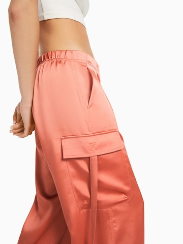 Bershka Tapered Cargobukser i orange