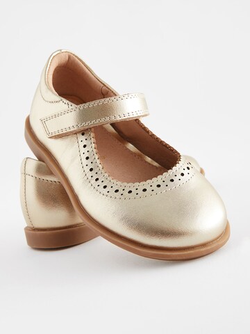 Next - Bailarina en oro