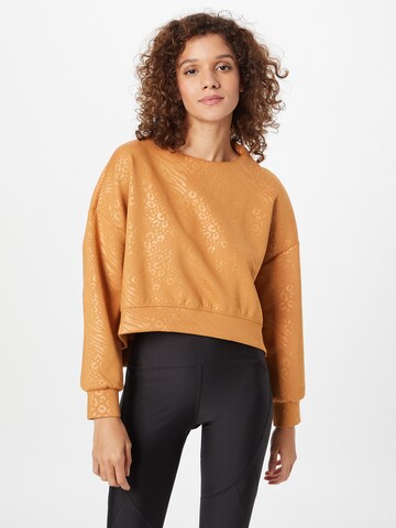 PUMA Sportief sweatshirt 'Fashion Luxe Embossed' in Bruin: voorkant