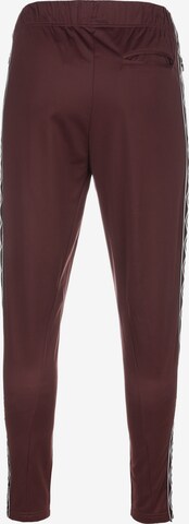 Effilé Pantalon de sport UMBRO en rouge