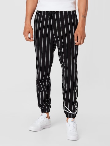 Karl Kani Tapered Trousers in Black: front