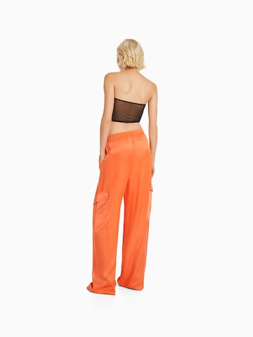 Bershka Široke hlačnice Kargo hlače | oranžna barva