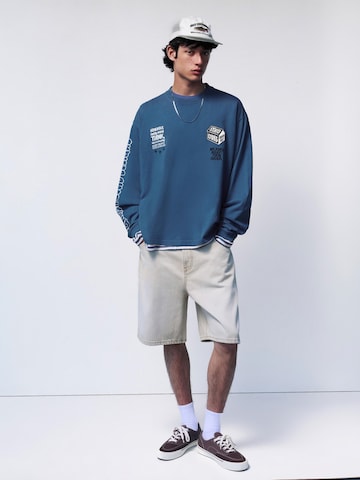Pull&Bear Tričko 'STWD COMMUNITY PLAYER' – modrá