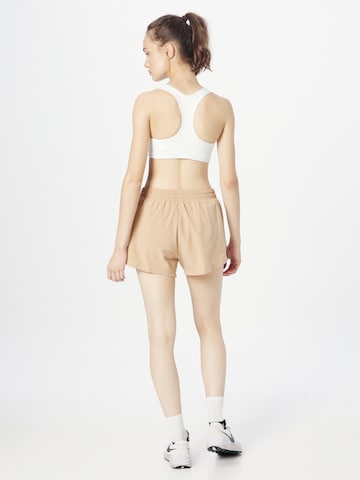 NIKE Regular Workout Pants in Beige