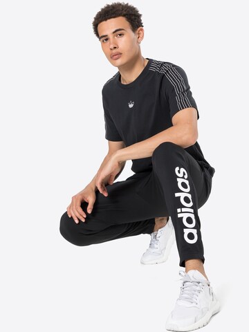 ADIDAS SPORTSWEAR Tapered Sports trousers 'Essentials Tapered Elastic Cuff Logo' in Black