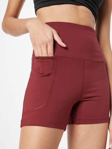 Skinny Pantaloni sportivi di ADIDAS TERREX in rosso