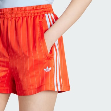 ADIDAS ORIGINALS Свободный крой Штаны в Оранжевый