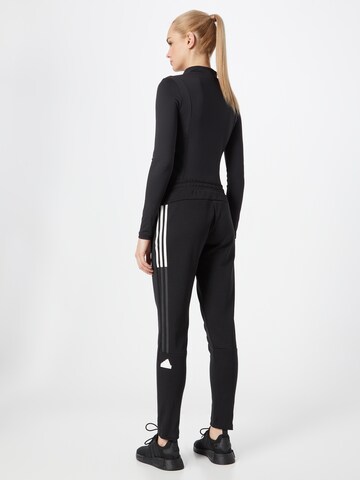 ADIDAS SPORTSWEAR Tapered Urheiluhousut 'Tricot' värissä musta