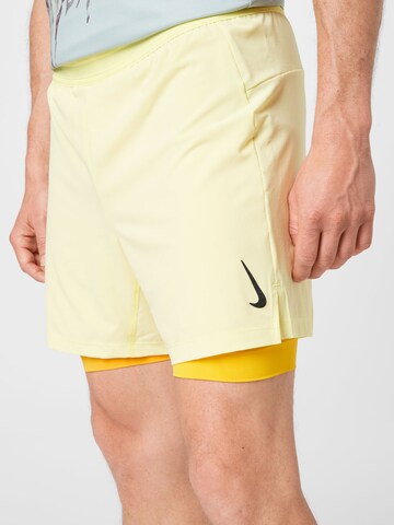 NIKE Regular Sports trousers in Yellow