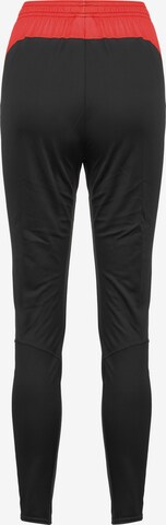 Effilé Pantalon de sport NIKE en noir
