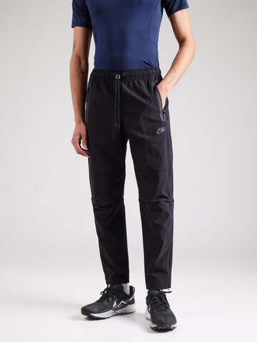 Nike Sportswear Tapered Trousers in Black: front