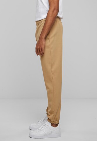 Tapered Pantaloni di Urban Classics in beige
