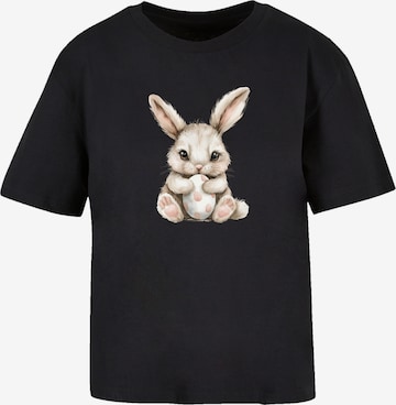 F4NT4STIC T-Shirt 'Niedlicher Osterhase Mit Ei' in Schwarz: Vorderseite
