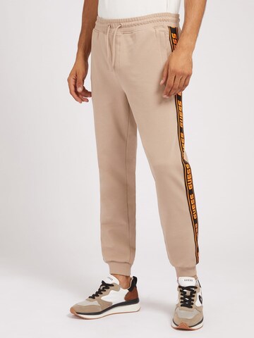 GUESS Tapered Pants in Brown: front