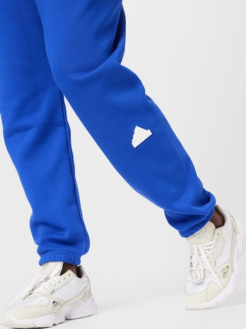 ADIDAS SPORTSWEAR Tapered Urheiluhousut 'Sweat' värissä sininen