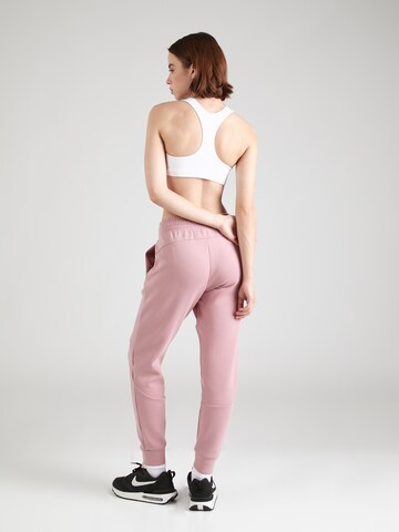 UNDER ARMOURTapered Sportske hlače 'Unstoppable' - roza boja
