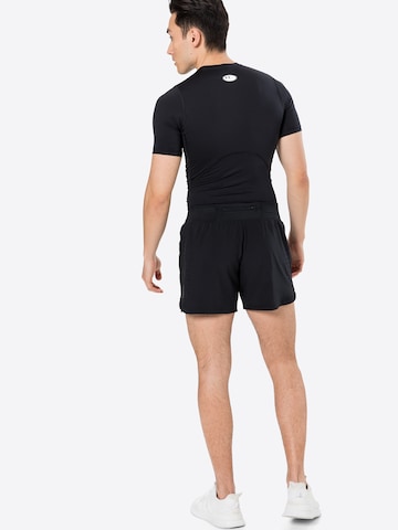 UNDER ARMOUR Regular Workout Pants 'Speedpocket' in Black