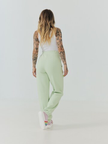 ABOUT YOU x Sharlota Tapered Pants 'Nala' in Green