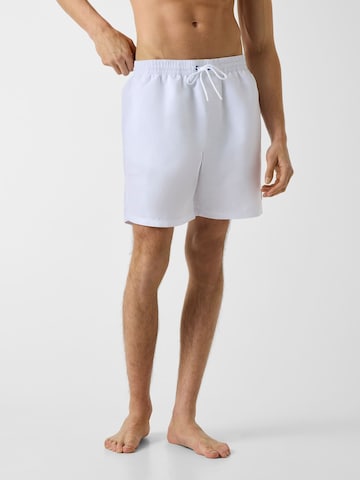 GUESS Board Shorts in White: front