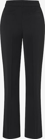 Flared Pantaloni con piega frontale di MORE & MORE in nero