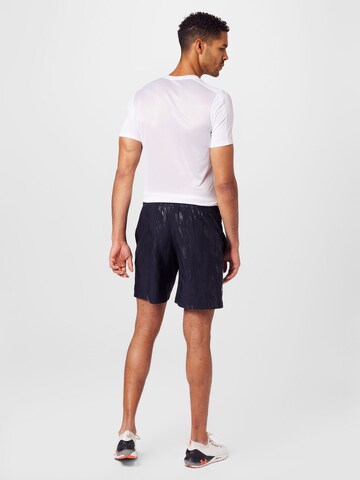 UNDER ARMOUR Regular Sportbroek 'Emboss' in Zwart