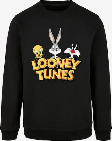 F4NT4STIC Sweatshirt 'Looney Tunes Group Faux Pocket' in Zwart: voorkant