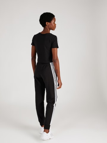 ADIDAS SPORTSWEAR Tapered Παντελόνι φόρμας σε μαύρο