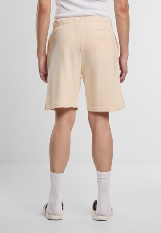 regular Pantaloni 'Terry' di Urban Classics in arancione